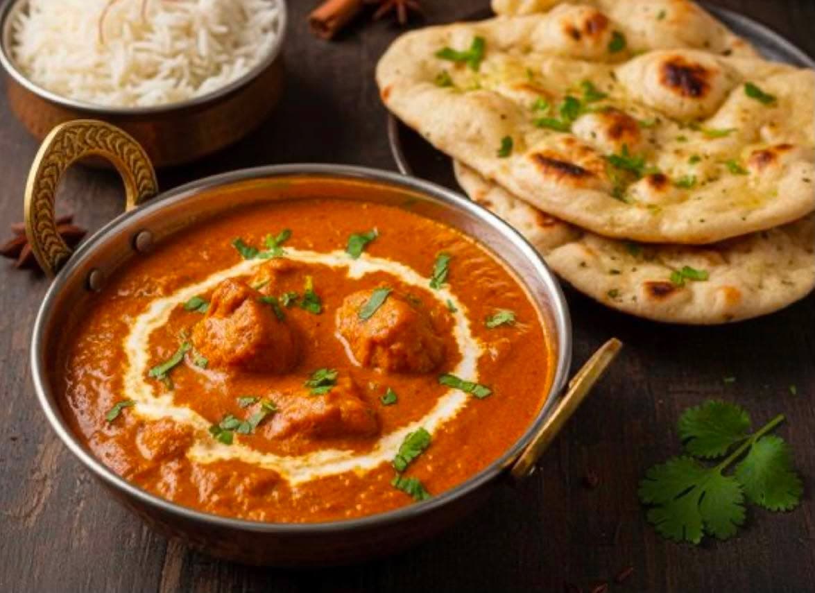 Butter Chicken — Boneless chicken from the clay oven, simmered in a rich cashew and tomato gravy.