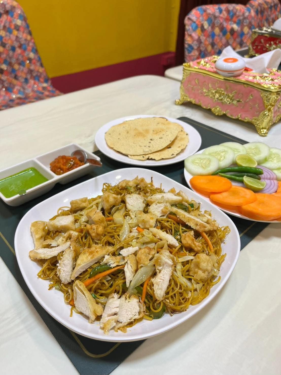 Chicken Hakka noodles served at the table