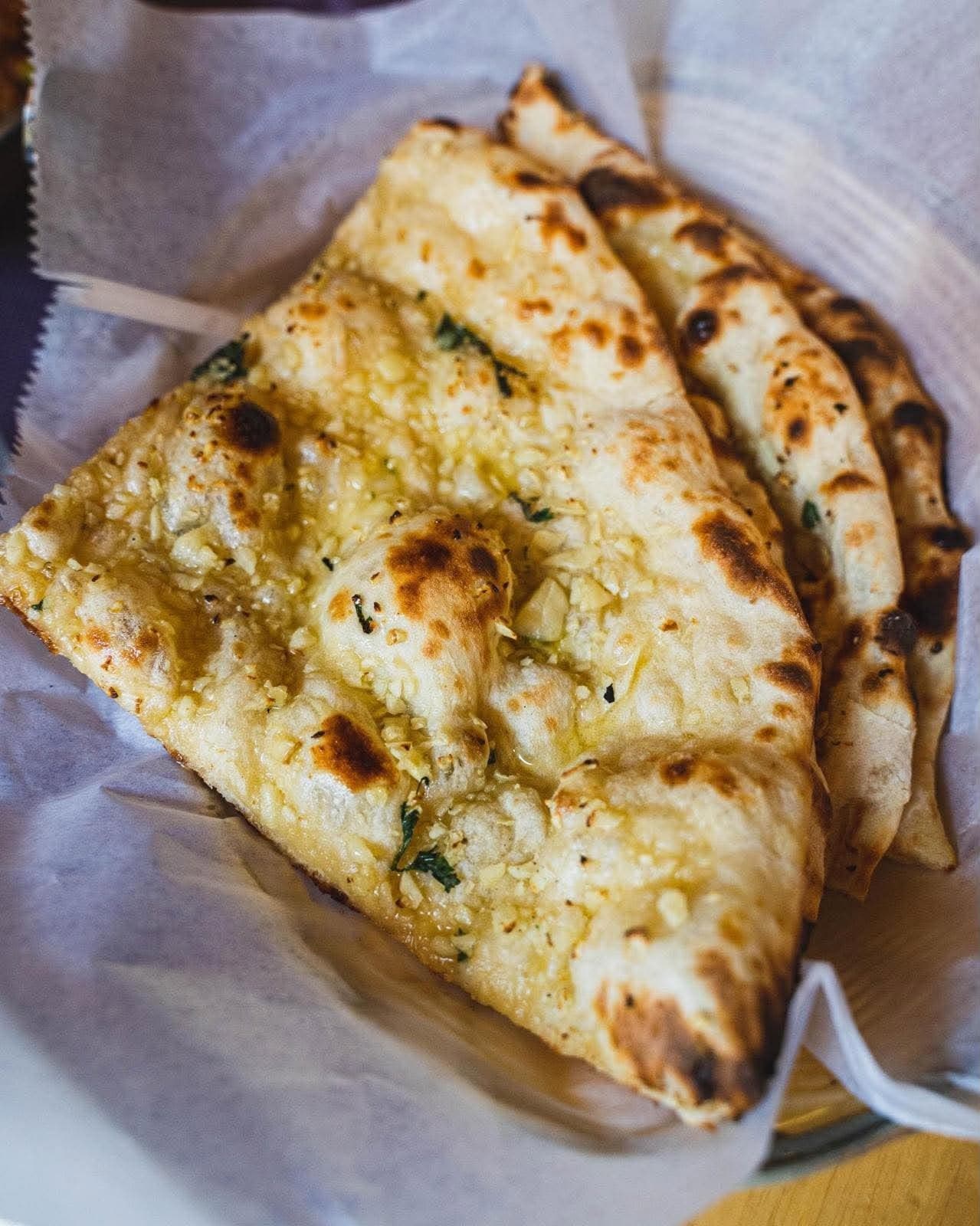 Garlic Naan — Naan bread topped with butter and garlic, baked in the tandoor.