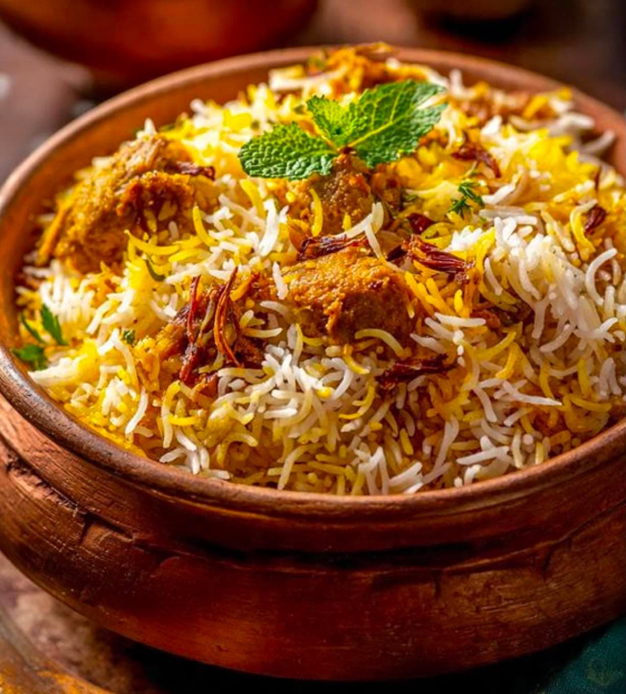 Mutton Dum Biryani — Fragrant basmati rice layered and slow dum-cooked with spiced mutton chunks.
