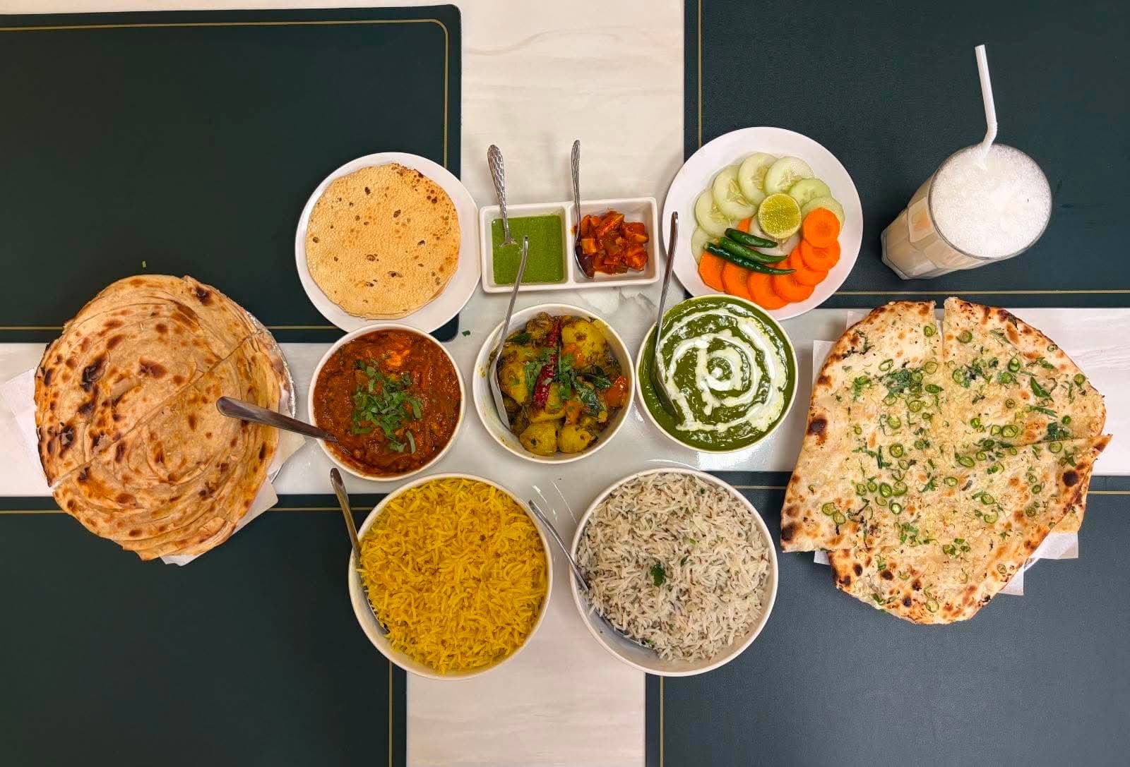 A full Indian spread — naan, rice, curries and lassi at Indian Oven Indian Food