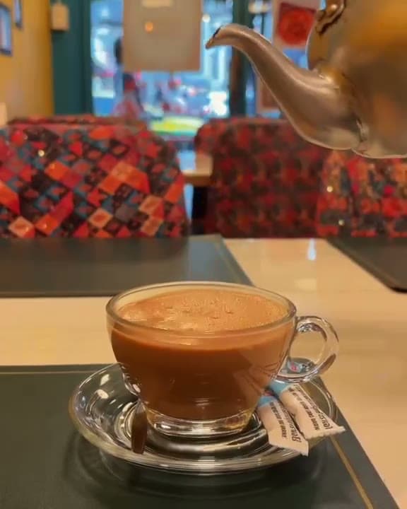 Masala chai poured fresh at the table